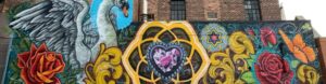 mural on exterior wall at st. paul's lutheran church featuring swan and purple heart