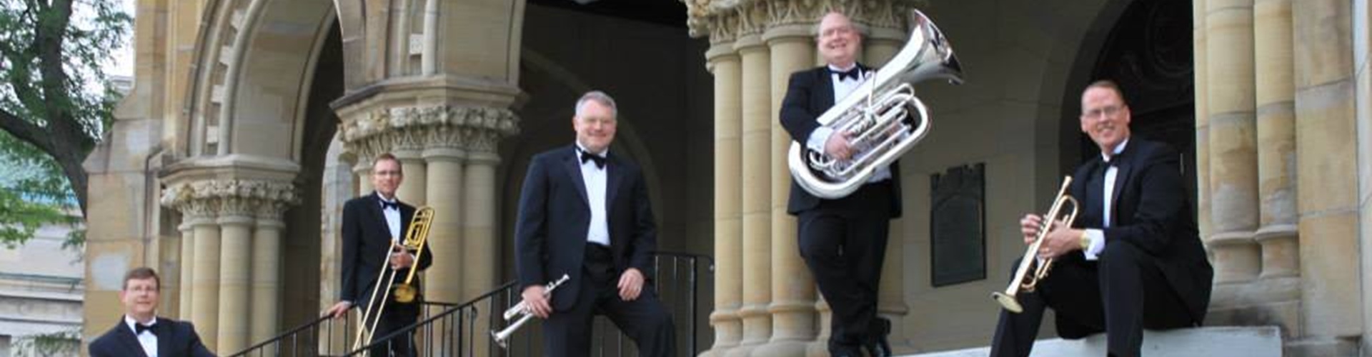 men of Academy Brass Quintet posing with musical instruments